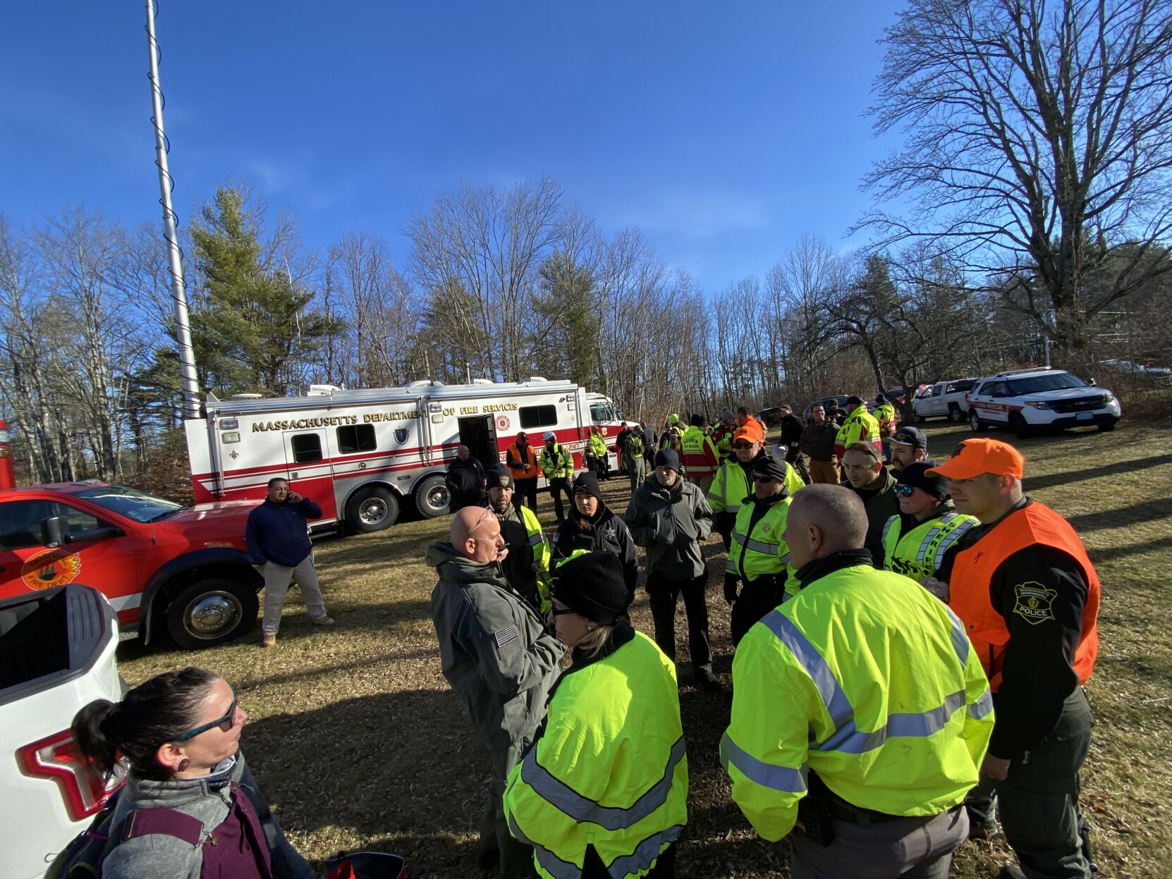 Group of rescuers in bright jackets talk